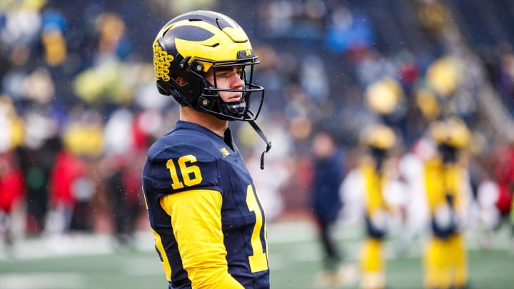 Michigan quarterback Davis Warren (16) warms up before the Indiana game at Michigan Stadium in Ann Arbor on Saturday, Oct. 14, 2023.