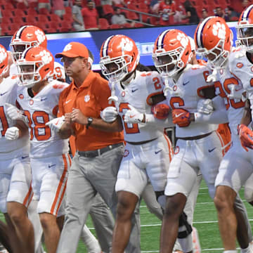 Aug 31, 2024; Atlanta, Georgia, USA;  Clemson Tigers head coach Dabo Swinney walks onto the field with players before the 2024 Aflac Kickoff Game with the University of Georgia Bulldogs at Mercedes-Benz Stadium.