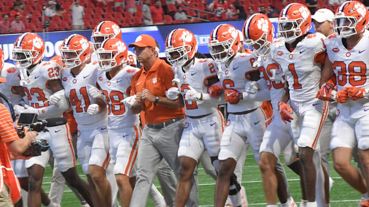 Aug 31, 2024; Atlanta, Georgia, USA;  Clemson Tigers head coach Dabo Swinney walks onto the field with players before the 2024 Aflac Kickoff Game with the University of Georgia Bulldogs at Mercedes-Benz Stadium.