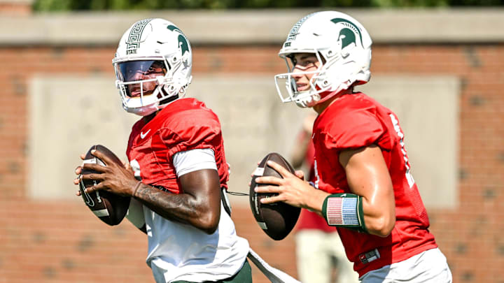 Michigan State's quarterback Aidan Chiles, left, and Alessio Milivojevic look to throw during football practice on Monday, Aug. 11, 2025, in East Lansing. Michigan State's quarterback Aidan Chiles, left, and Alessio Milivojevic look to throw during football practice on Monday, Aug. 11, 2025, in East Lansing.