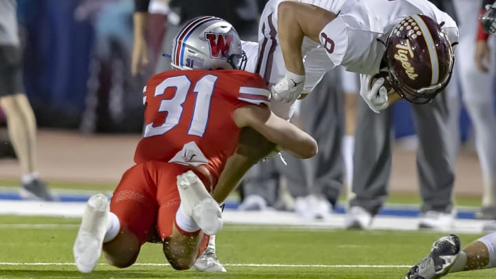 Westlake middle linebacker Elliott Schaper (31) tackles Dripping Springs receiver Nick Tyndall (8) on Oct. 13, 2023.