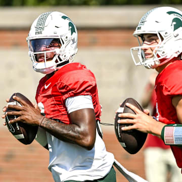 Michigan State's quarterback Aidan Chiles, left, and Alessio Milivojevic look to throw during football practice on Monday, Aug. 11, 2025, in East Lansing.