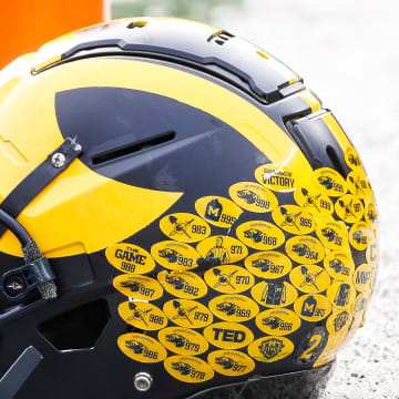 Michigan running back Blake Corum's helmet sits on the turf during warmups before the Ohio State game at Michigan Stadium in Ann Arbor on Saturday, Nov. 25, 2023.