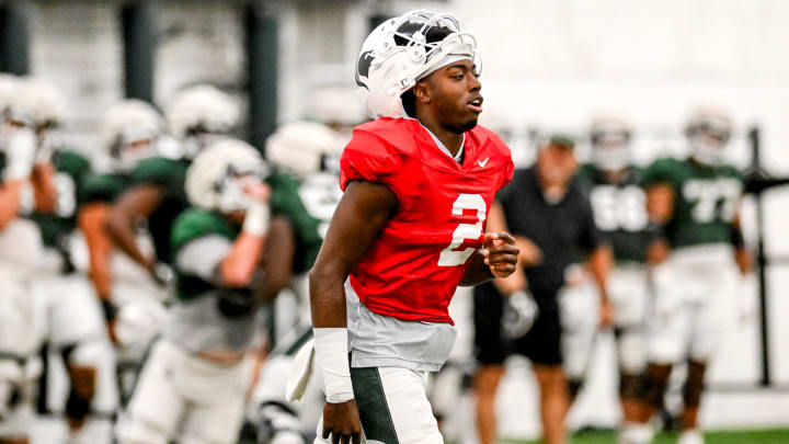 Michigan State's Aidan Chiles heads over with the quarterbacks for a drill during camp on Monday, Aug. 5, 2024, at the indoor practice facility in East Lansing.