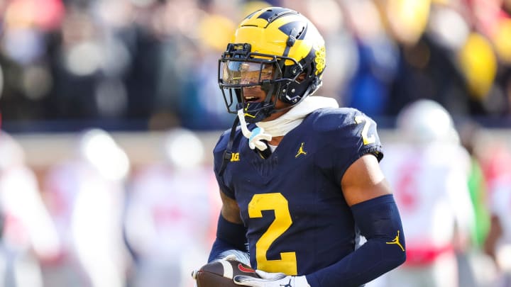 Michigan defensive back Will Johnson (2) reacts after intercepting a pass from Ohio State quarterback Kyle McCord (6) during the first half at Michigan Stadium in Ann Arbor on Saturday, Nov. 25, 2023.