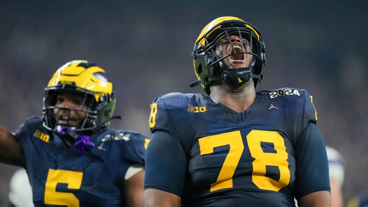 Michigan defensive lineman Kenneth Grant celebrates a sack on Washington quarterback Michael Penix Jr. in the second quarter during the College Football Playoff national championship game against Washington at NRG Stadium in Houston, Texas on Monday, Jan. 8, 2024.