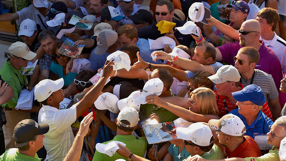 Tiger Woods signs for fans at the 2012 Arnold Palmer Invitational.