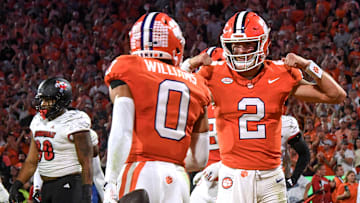 Nov 2, 2024; Clemson, South Carolina, USA; Clemson Tigers quarterback Cade Klubnik (2) celebrates after throwing a touchdown pass to wide receiver Antonio Williams (0) against the Louisville Cardinals during the first quarter at Memorial Stadium. Mandatory Credit: Ken Ruinard-Imagn Images