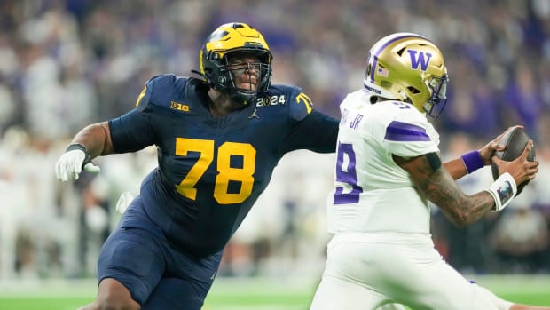 Michigan defensive lineman Kenneth Grant (78) reaches out to sack Washington quarterback Michael Penix Jr. (9) in the second quarter during the College Football Playoff national championship game against Washington at NRG Stadium in Houston, Texas on Monday, January 8, 2024.