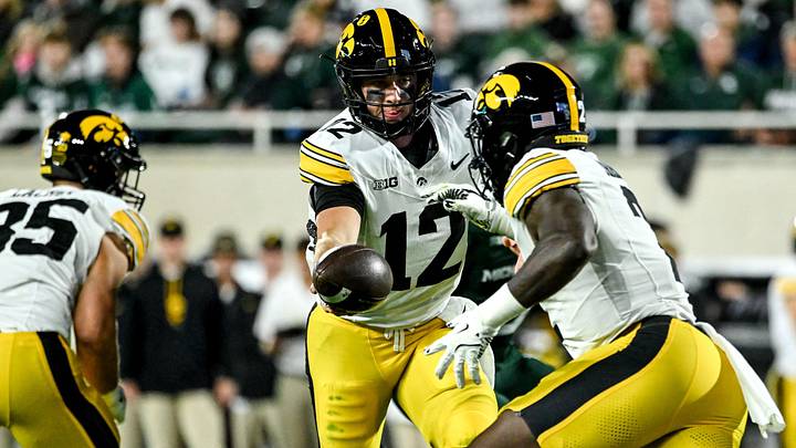 Iowa's Cade McNamara, left, hands off to Kaleb Johnson during the first quarter in the game against Michigan State on Saturday, Oct. 19, 2024, at Spartan Stadium in East Lansing.