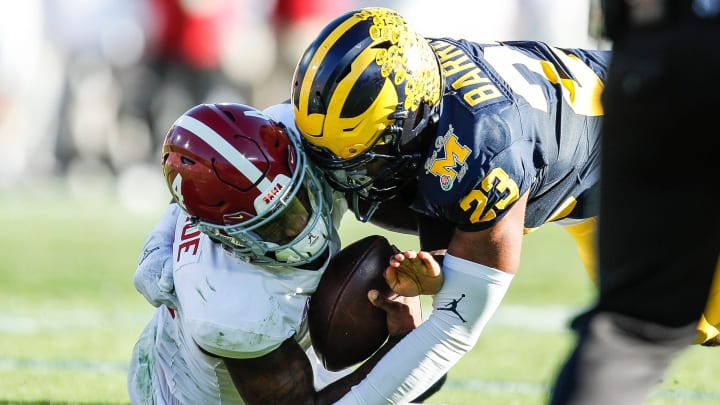 Michigan linebacker Michael Barrett tackles Alabama quarterback Jalen Milroe during the first half of the Rose Bowl in Pasadena, California, on Monday, Jan. 1, 2024.