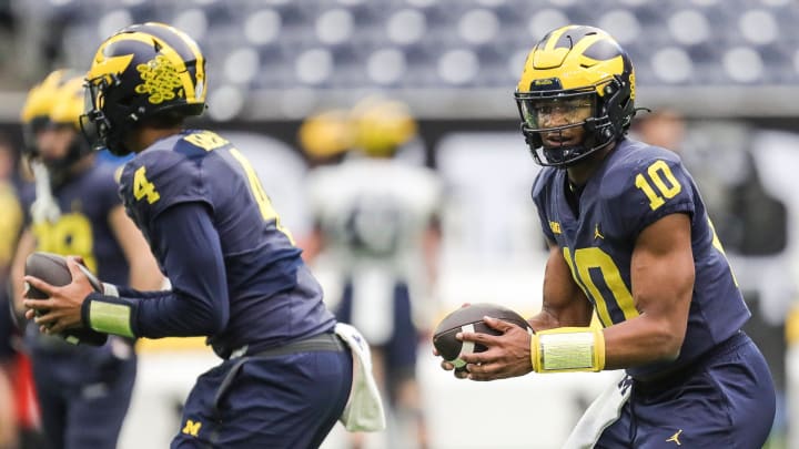 Michigan quarterback Alex Orji (10) next to quarterback Jayden Denegal (4) practice during open practice at NRG Stadium in Houston, Texas on Saturday, Jan. 6, 2024.