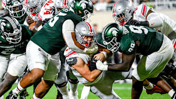 Michigan State's Ben Roberts, left, sacks Ohio State's Will Howard, center, with help from teammate Quindarius Dunnigan during the second quarter on Saturday, Sept. 28, 2024, at Spartan Stadium in East Lansing.