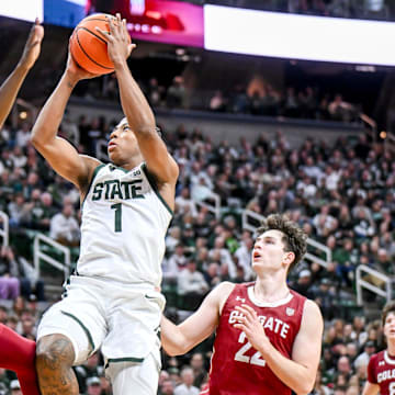 Michigan State's Jeremy Fears Jr., center, scores between Colgate's Jalen Cox, left, and Andrew Alekseyenko during the first half on Monday, Nov. 3, 2025, at the Breslin Center in East Lansing.