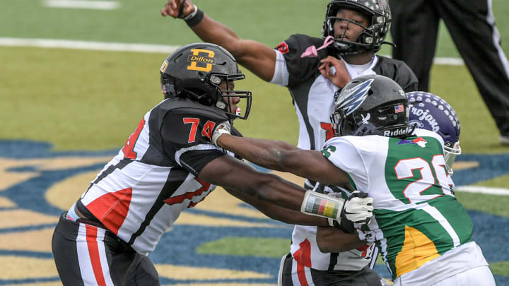 South Carolina defensive back Tyler Jones of Dutch Fork High, SC offensive MVP, passes near the blocking by South Carolina offensive lineman Josiah Thompson of Dillon High, USC Gamecocks commit, and North Carolina defensive lineman Mason Brooks of Salisbury High during the second quarter of the Shrine Bowl of the Carolinas football game at Viking Stadium in Spartanburg, S.C. 