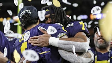 Michigan running backs Blake Corum, left, and Donovan Edwards hug during the trophy presentation after the 34-13 win over Washington at the national championship game at NRG Stadium in Houston on Monday, Jan. 8, 2024.