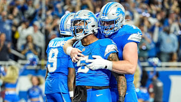 Detroit Lions running back David Montgomery (5) celebrates scoring a touchdown against Los Angeles Rams with center Frank Ragnow (77) during overtime at Ford Field in Detroit on Sunday, September 8, 2024.