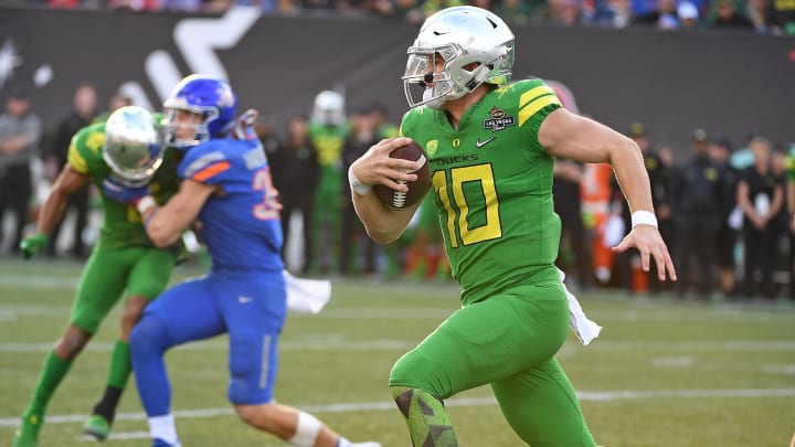 Dec 16, 2017; Las Vegas, NV, USA; Oregon Ducks quarterback Justin Herbert (10) is flushed out of the pocket during the second half of play against the Boise Broncos in the 2017 Las Vegas Bowl at Sam Boyd Stadium. Mandatory Credit: Stephen R. Sylvanie-USA TODAY Sports