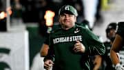 Michigan State's head coach Jonathan Smith runs onto the field with the team before the gam against Michigan Saturday, Oct. 25, 2025, at Spartan Stadium in East Lansing.