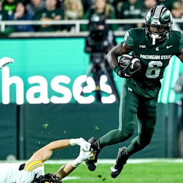 Michigan State's Nick Marsh, right, breaks a tackle attempt by Iowa's John Nestor during the third quarter on Saturday, Oct. 19, 2024, at Spartan Stadium in East Lansing.