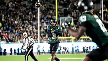 Michigan State's Aidan Chiles, left, throws the ball to Ademola Faleye during the second quarter in the game against Purdue on Friday, Nov. 22, 2024, at Spartan Stadium in East Lansing.