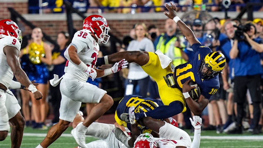 Michigan quarterback Alex Orji (10) is tackled by Fresno State defensive back Al'zillion Hamilton (3) during the second half at Michigan Stadium in Ann Arbor on Saturday, Aug. 31, 2024.