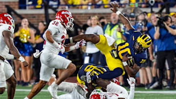 Michigan quarterback Alex Orji (10) is tackled by Fresno State defensive back Al'zillion Hamilton (3) during the second half at Michigan Stadium in Ann Arbor on Saturday, Aug. 31, 2024.