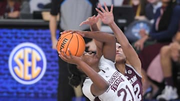 Mar 1, 2023; Greenville, SC, USA; Mississippi State guard Debreasha Powe (21) shoots near Texas A&M forward Aaliyah Patty (32) during the first quarter of the SEC Women's Basketball Tournament at Bon Secours Wellness Arena. Mandatory Credit: Ken Ruinard-Imagn Images