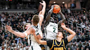 Michigan State's Kur Teng, right, pulls down a rebound over Iowa's Isaia Howard during the first half on Tuesday, Dec. 2, 2025, at the Breslin Center in East Lansing.