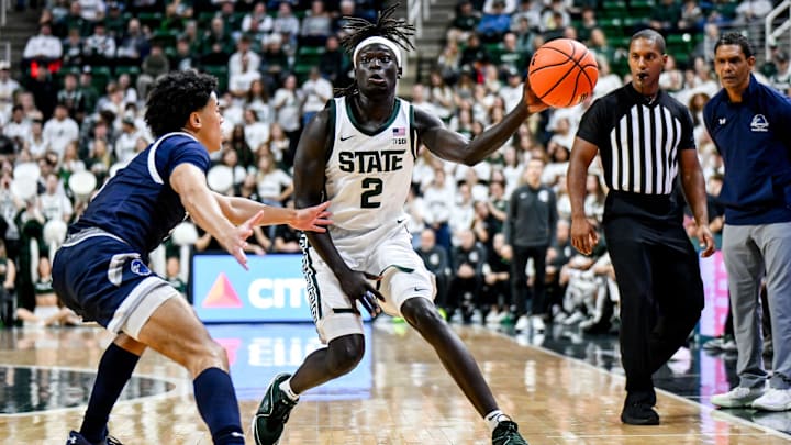 Michigan State's Kur Teng, right, passes the ball against Monmouth during the first half on Monday, Nov. 4, 2024, at the Breslin Center in East Lansing.