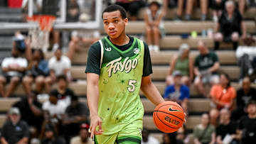 Team Faygo and Michigan State's Divine Ugochukwu moves the ball against Team Motorcars during the Moneyball Pro-Am on Tuesday, June 24, 2025, at Holt High School.