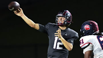Westside High senior quarterback Cutter Woods (12) passes near Belton-Honea Path High junior Kylan Dixon (61) during the second quarter at Westside High in Anderson, S.C. Friday, September 13, 2024.