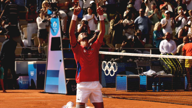 Djokovic celebrates winning Olympic gold.