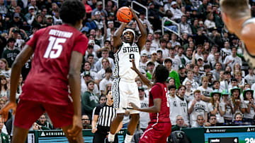 Michigan State's Trey Fort, left, makes a 3-pointer as Colgate's Jalen Cox defends during the second half on Monday, Nov. 3, 2025, at the Breslin Center in East Lansing.