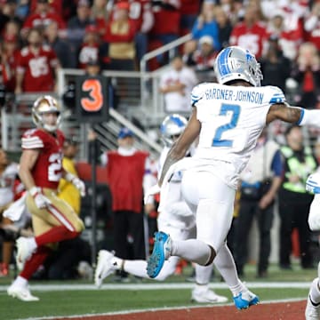 49ers wide receiver Brandon Aiyuk catches the ball around Lions defensive backs C.J. Gardner-Johnson, left, and Cam Sutton for a touchdown in the third quarter of the Lions' 34-31 loss in the NFC championship game in Santa Clara, California, on Jan. 28, 2024.