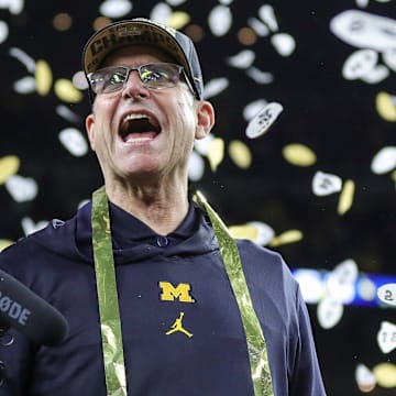 Michigan head coach Jim Harbaugh celebrates during the trophy presentation after the 34-13 win over Washington at the national championship game at NRG Stadium in Houston on Monday, Jan. 8, 2024.