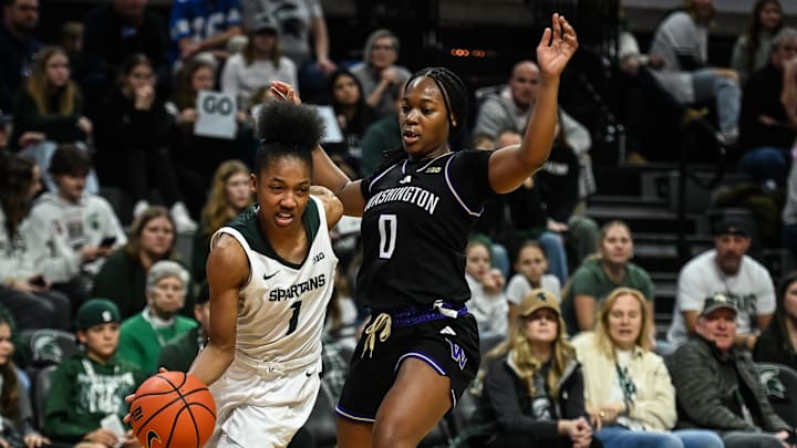 Jaddan Simmons of MSU drives into the paint against Sayvia Sellers of Washington Huskies, Sunday, Jan. 12, 2025, at the Breslin Center in East Lansing.