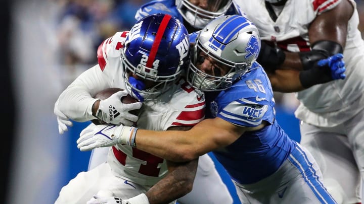 Detroit Lions linebacker Jack Campbell (46) tackles New York Giants running back James Robinson (24) 