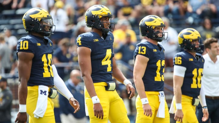 Michigan quarterbacks Alex Orji (10), Jayden Denegal (4), Jack Tuttle (13) and Davis Warren (16) practice before the UNLV game at Michigan Stadium in Ann Arbor on Saturday, Sept. 9, 2023.