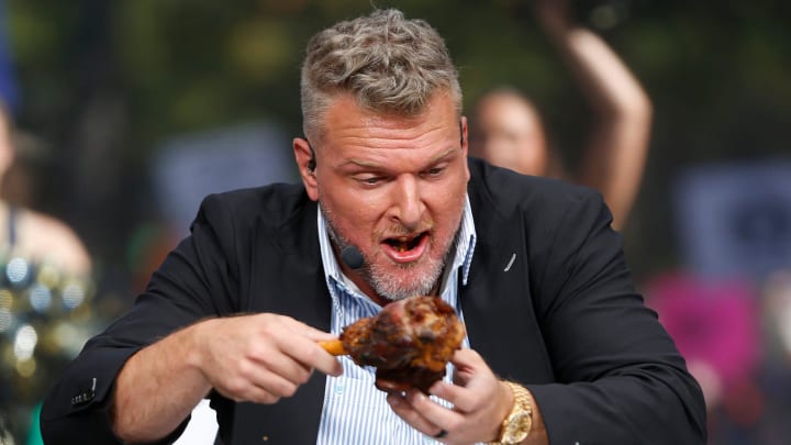 ESPN's Pat McAfee goes to eat the lamb provided by Fiddler Hearth during \"College GameDay\" Saturday at Notre Dame.