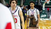 Orchard Lake St. Marys Jayden Savoury (31) holds the MHSAA trophy after defeating North Farmington