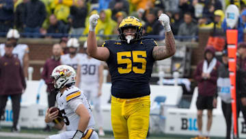 Michigan defensive lineman Mason Graham celebrates after sacking Minnesota quarterback Max Brosmer, in the background, during first-half action between Michigan and Minnesota at Michigan Stadium in Ann Arbor on Saturday, Sept. 28, 2024.