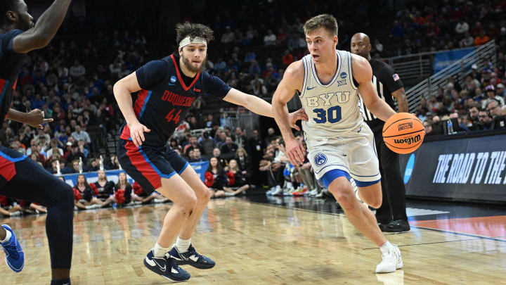 Mar 21, 2024; Omaha, NE, USA; Brigham Young Cougars guard Dallin Hall (30) looks to drive against Duquesne Dukes guard Jake DiMichele (44) in the second half during the first round of the NCAA Tournament at CHI Health Center Omaha.