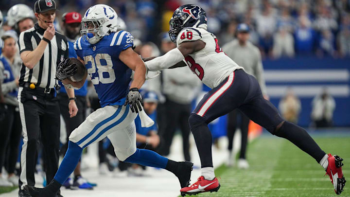 Indianapolis Colts safety Ronnie Harrison Jr. (48) runs Indianapolis Colts running back Jonathan Taylor (28) out of bounds on Saturday, Jan. 6, 2024, during a game against the Houston Texans at Lucas Oil Stadium in Indianapolis.