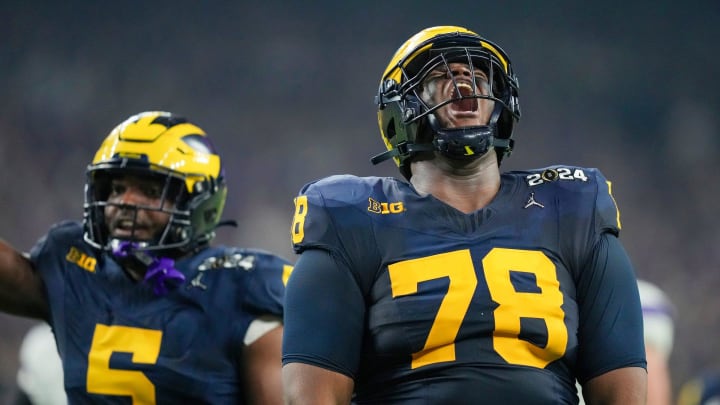 Michigan defensive lineman Kenneth Grant celebrates a sack on Washington quarterback Michael Penix Jr. in the second quarter during the College Football Playoff national championship game against Washington at NRG Stadium in Houston, Texas on Monday, Jan. 8, 2024.