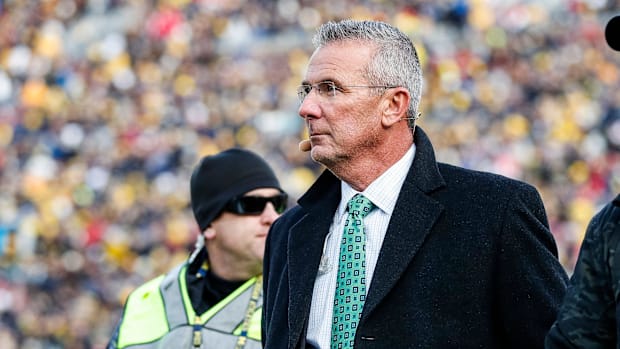 Ohio State Buckeyes former head coach Urban Meyer walks by the end zone during the first half between Michigan and Ohio State