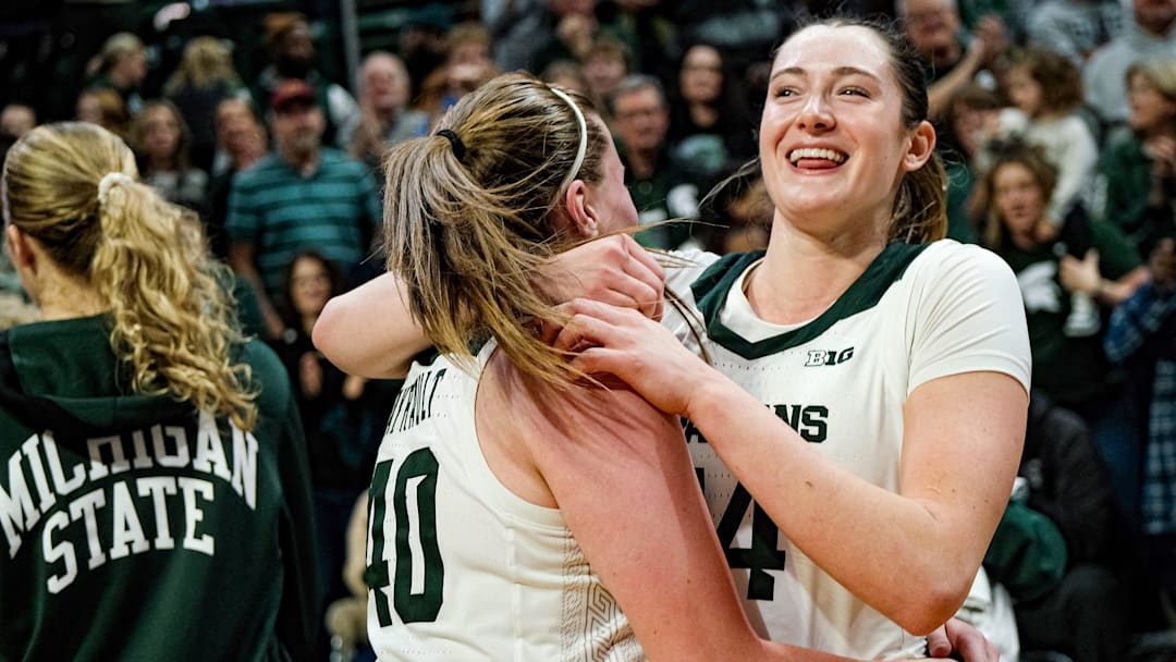 Michigan State's Julia Ayrault (40) and Grace VanSlooten (14) celebrate after going 10-0 and defeating Iowa 68-66 at the Breslin Center Sunday, Dec. 15, 2024.