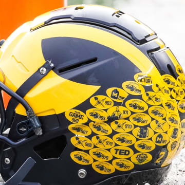 Michigan running back Blake Corum's helmet sits on the turf during warmups before the Ohio State game at Michigan Stadium in Ann Arbor on Saturday, Nov. 25, 2023.