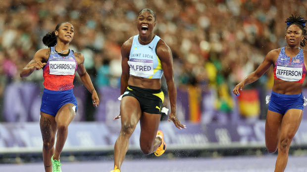 Sprinter Julien Alfred wins the 100-meter final at the Paris Olympics.