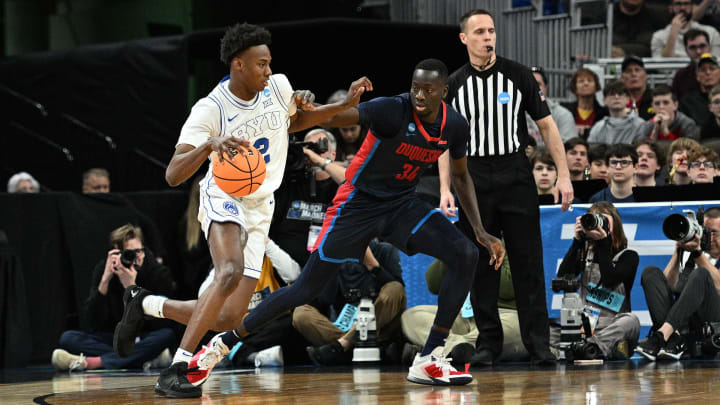 Mar 21, 2024; Omaha, NE, USA; Brigham Young Cougars guard Jaxson Robinson (2) drives against Duquesne Dukes forward Fousseyni Drame (34) in the first half during the first round of the NCAA Tournament at CHI Health Center Omaha. Mandatory Credit: Steven Branscombe-USA TODAY Sports